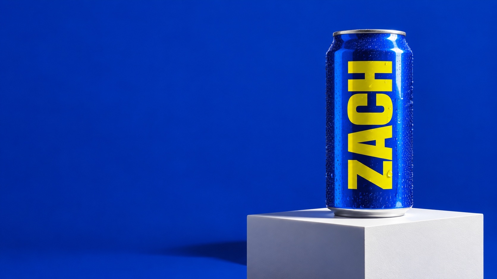 A single can of ZACH on a pedestal under studio lights.